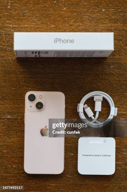 iphone 13 mini pink unboxing - iphone on table overhead stock pictures, royalty-free photos & images