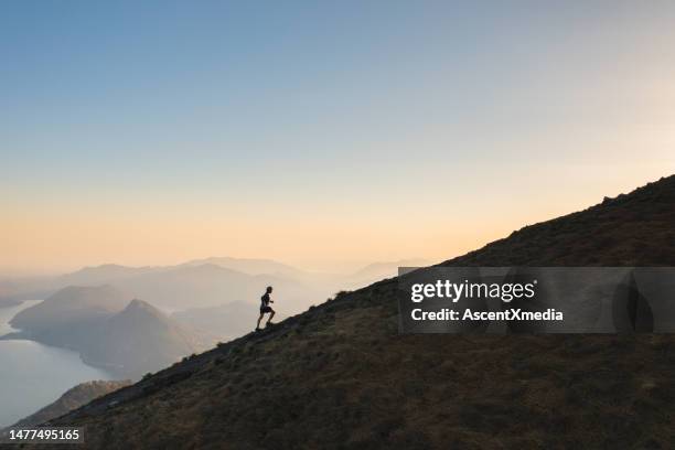 aerial view of trail runners ascending mountain ridge - cross country running stock pictures, royalty-free photos & images