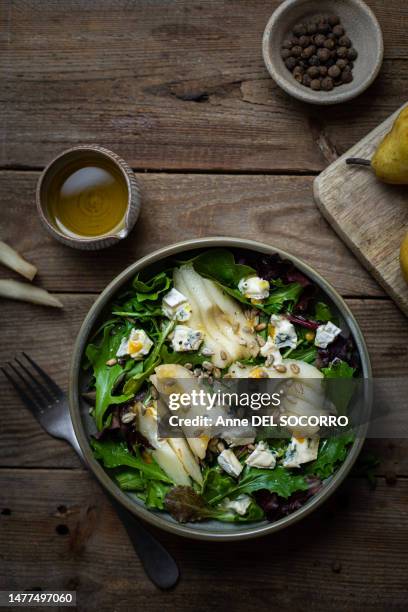 salad with pears blue cheese and sunflower seeds - roquefort cheese stock pictures, royalty-free photos & images
