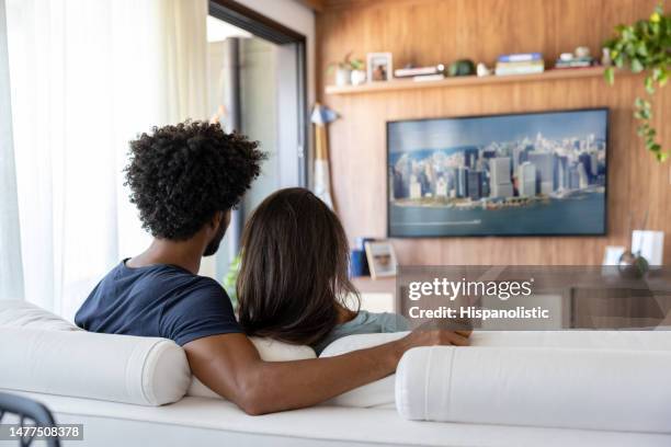 loving couple watching television at home - stay at home order stock pictures, royalty-free photos & images
