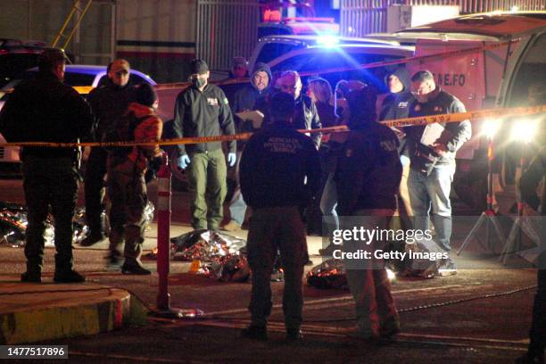 Rescuers work to take the injured and the corpses of the victims out of the premises after a fire at an immigration detention center in Northern...