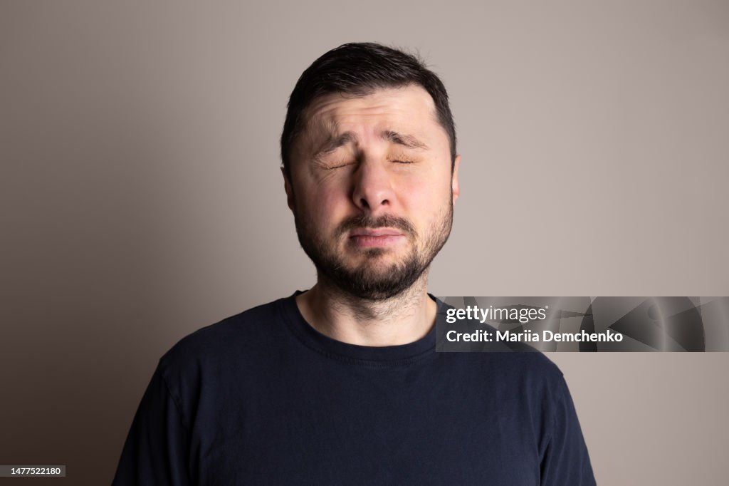 Portrait of squinting bearded handsome man
