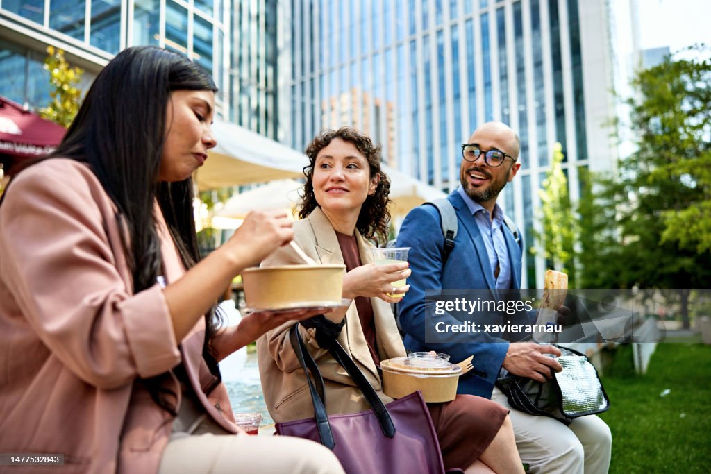 Office workers eating lunch together