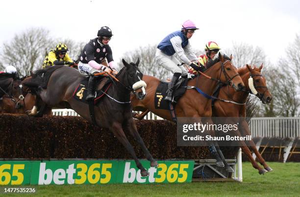 Winner Drop Him In ridden by Sean Bowen and Mixedwave ridden by Paul O'Brien clear a fence the Racing TV Novices' Handicap Steeple Chase at...