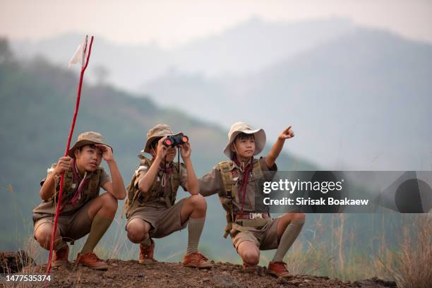 asian scout leader stands and points out - boy scout camping stock pictures, royalty-free photos & images