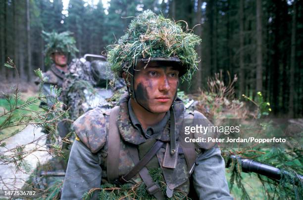 Bunderswehr recruits from Paratrooper Battalion 273 take part in a training exercise in a forest near the West German Army's school for airborne...