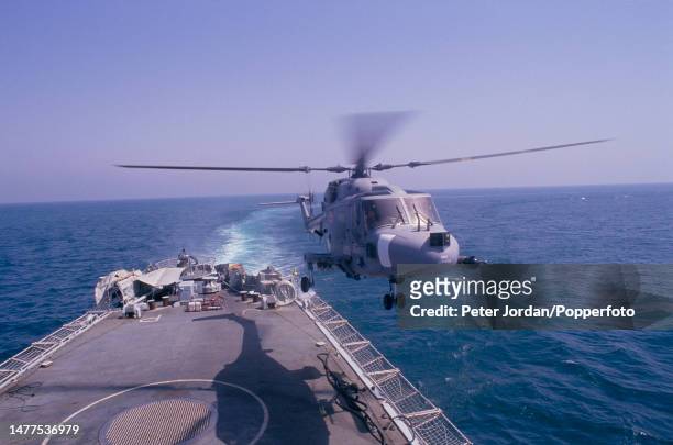 Westland Lynx military helicopter takes off from the flight deck of Royal Navy Leander-class frigate HMS Jupiter on Armilla patrol in the Persian...