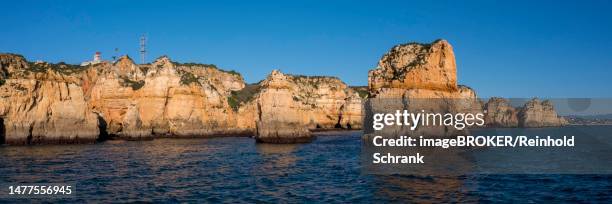 praia da marinha, rocks and cliffs, steep coast in the algarve, portugal - algarve stock illustrations