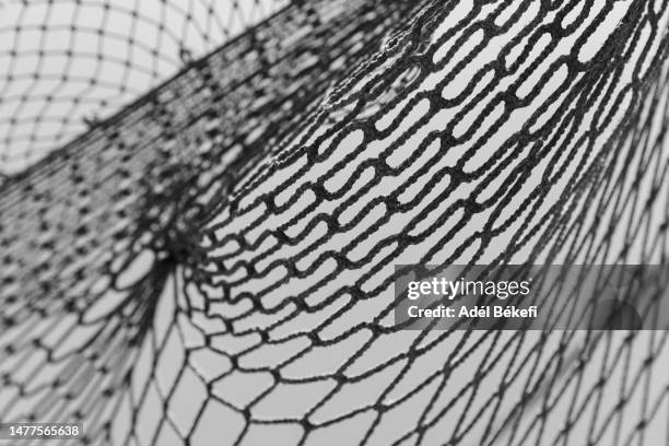 close-up of black fishing net - rede têxtil imagens e fotografias de stock