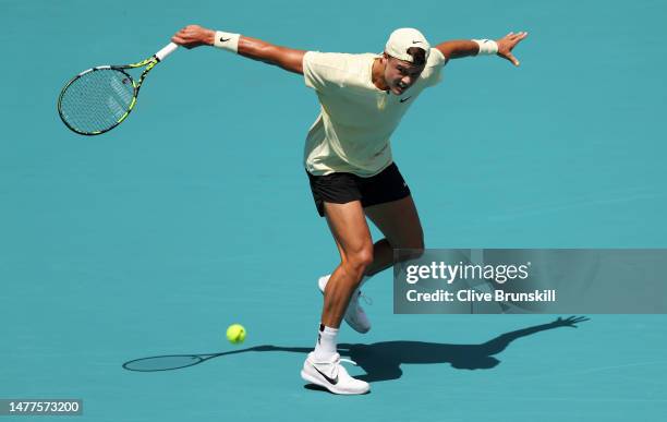 Holger Rune of Denmark plays a backhand slice against Taylor Fritz of the United States in their fourth round match at Hard Rock Stadium on March 28,...