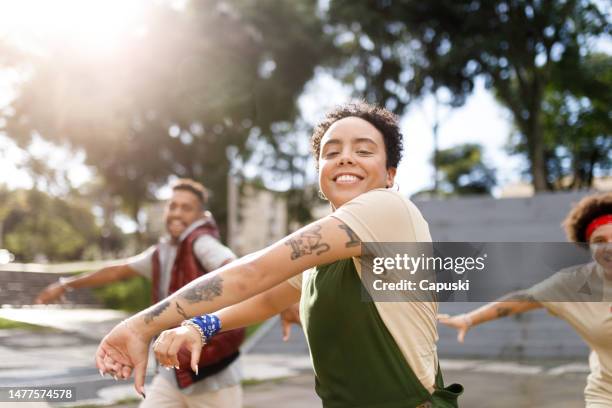 happy woman dancing with friends - funk music stock pictures, royalty-free photos & images