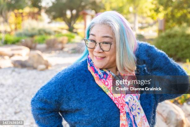 portrait of an asian woman wearing a scarf - older woman colored hair stock pictures, royalty-free photos & images