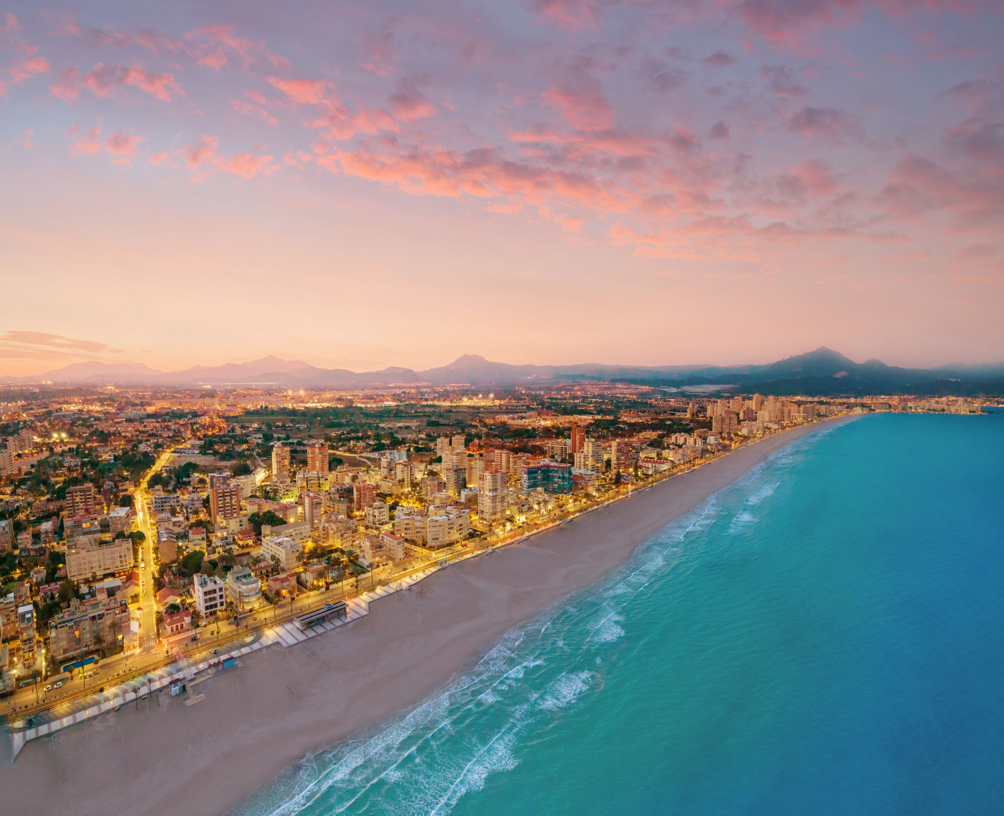 Campello beach at sunset in Alicante drone aerial view in Mediterranean sea Campello beach at sunset in Alicante drone aerial view in Mediterranean sea