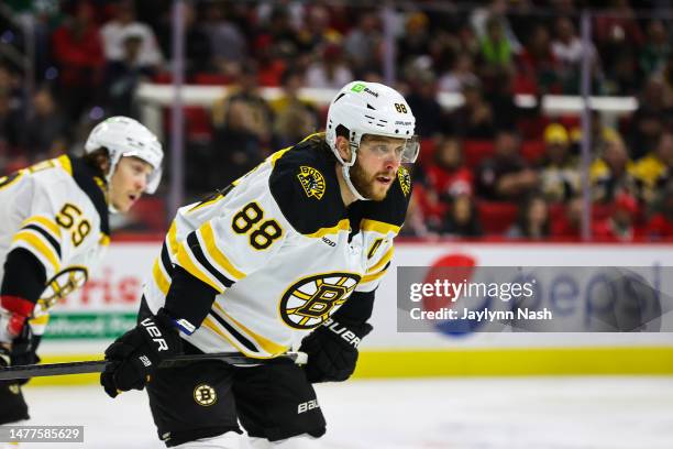 David Pastrnak of the Boston Bruins looks on during the second period of the game against the Carolina Hurricanes at PNC Arena on March 26, 2023 in...