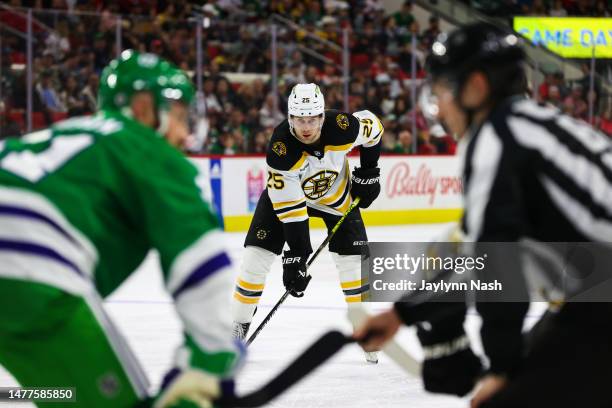 Brandon Carlo of the Boston Bruins looks on during the third period of the game against the Carolina Hurricanes at PNC Arena on March 26, 2023 in...