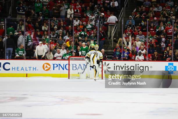 Jeremy Swayman of the Boston Bruins celebrates a win during the shootout of the game against the Carolina Hurricanes at PNC Arena on March 26, 2023...