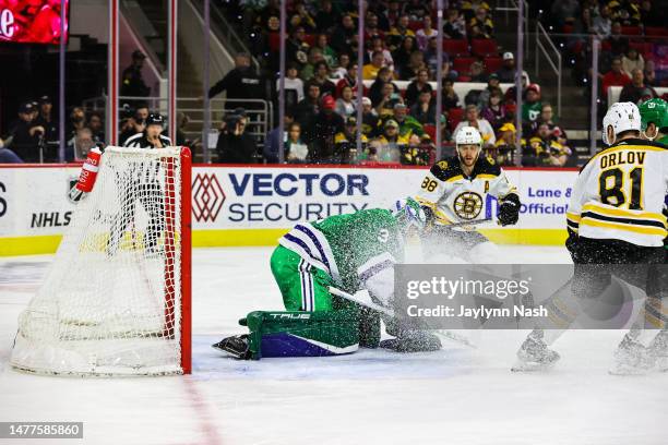 Frederik Andersen of the Carolina Hurricanes gets iced in the face during the third period of the game against the Boston Bruins at PNC Arena on...