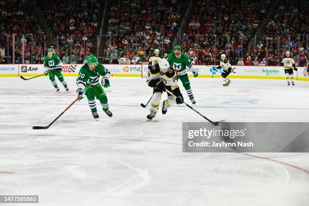 Jake DeBrusk of the Boston Bruins skates with the puck during the third period of the game against the Boston Bruins at PNC Arena on March 26, 2023...