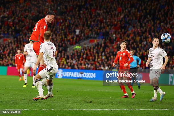 Kieffer Moore of Wales scores the team's first goal during the UEFA EURO 2024 qualifying round group D match between Wales and Latvia at Cardiff City...