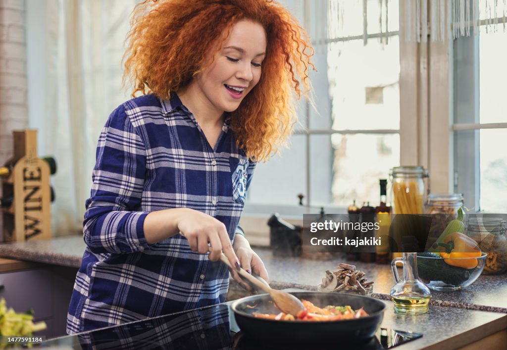 Woman steaming mixed vegetables in the kitchen