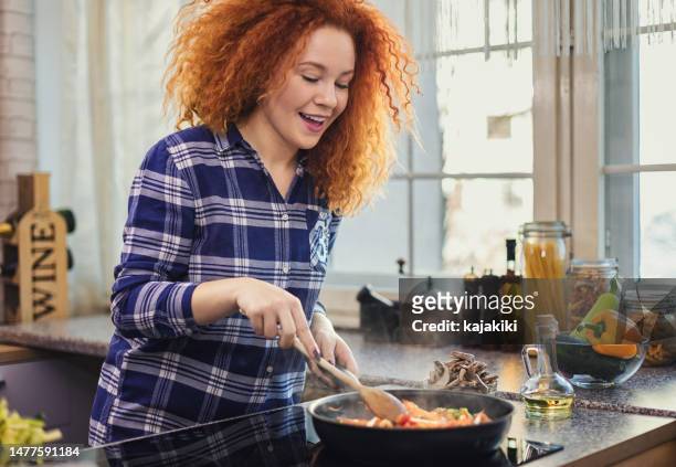 woman steaming mixed vegetables in the kitchen - stir frying european stock pictures, royalty-free photos & images