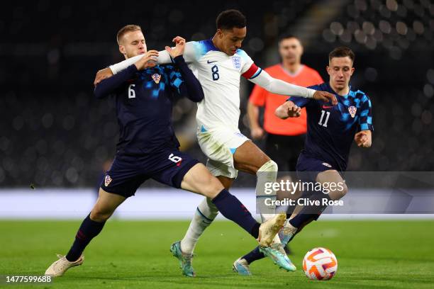 Jacob Ramsey of England is challenged by Hrvoje Smolcic of Croatia during the International Friendly match between England U21s and Croatia U21s at...