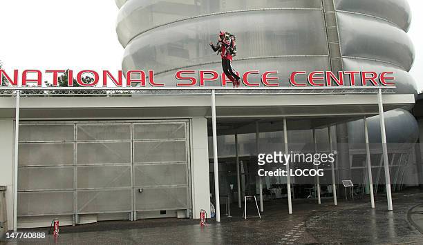 In this handout image provided by LOCOG, Day 46 of the Olympic Flame Torch Relay begins at the National Space Centre as stuntman Eric Scott carries...