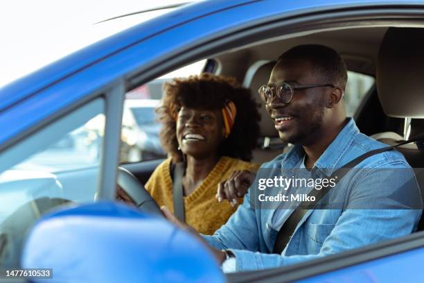 cheerful african american couple in car - car rental stock pictures, royalty-free photos & images