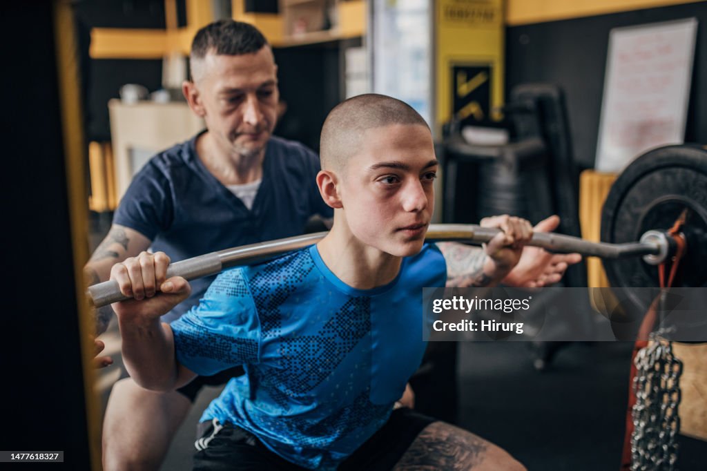 Teenage boy training with fitness instructor