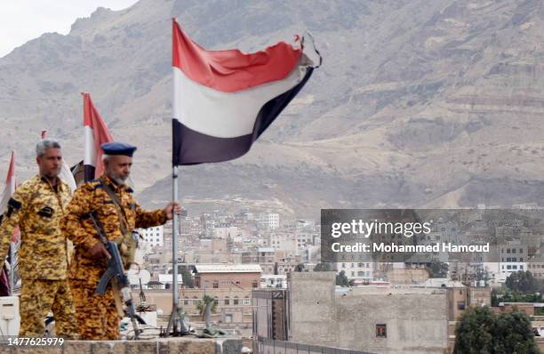 Yemen's Houthi loyal soldiers guard during a protest staged to mark the war's 8th anniversary, on March 26, 2023 in Sana'a, Yemen. The eighth...