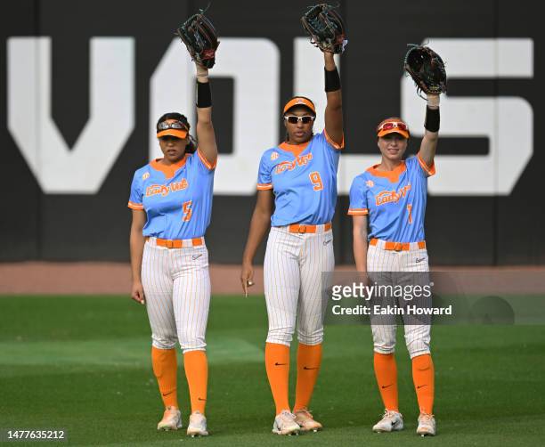 Rylie West, Kiki Milloy, and Katie Taylor of the Tennessee Lady Vols stand in the outfield before their game against the Alabama Crimson Tide at...