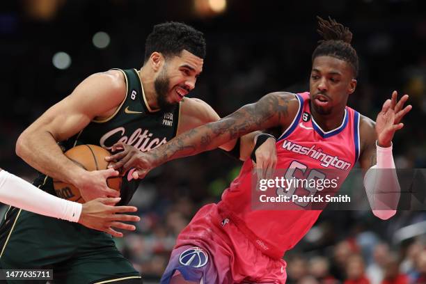 Jayson Tatum of the Boston Celtics drives past Delon Wright of the Washington Wizards during the first half at Capital One Arena on March 28, 2023 in...