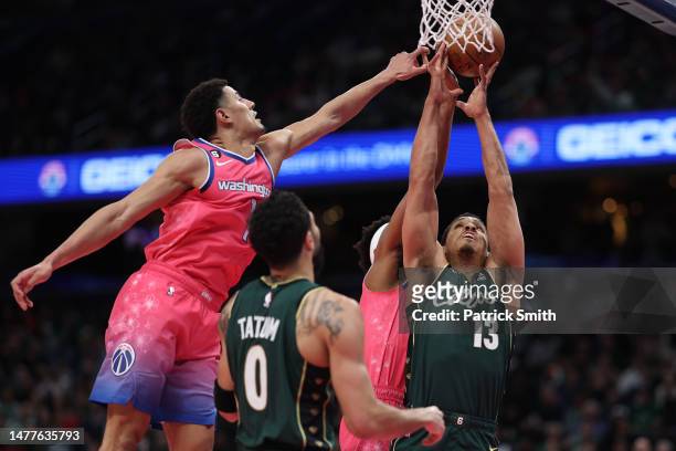 Malcolm Brogdon of the Boston Celtics shoots in front of Johnny Davis of the Washington Wizards during the first half at Capital One Arena on March...