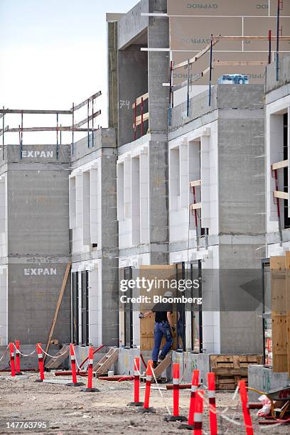 An employee enters a new townhouse during construction in the Havnevigen neighbourhood of the Islands Brygge, or Iceland Quay, development in central...