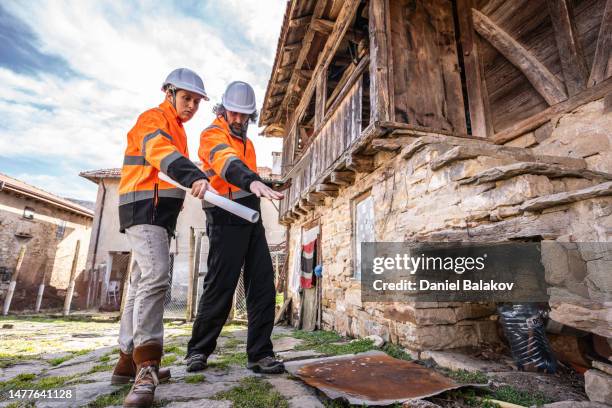 renovation of wooden house. engineers taking measures on the field. - timber framed stock pictures, royalty-free photos & images