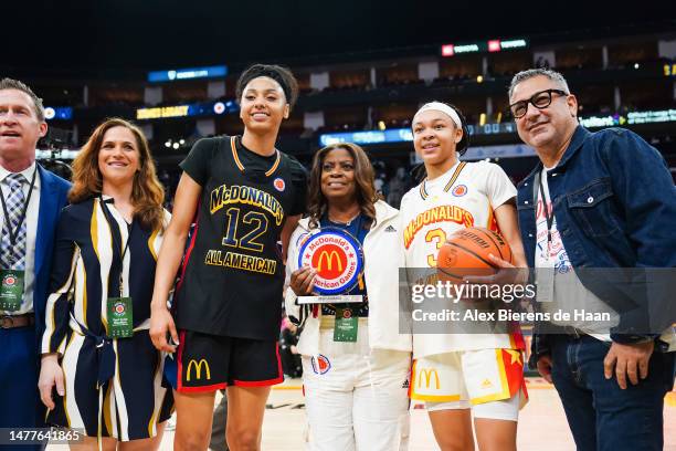 JuJu Watkins of the West team and Hannah Hildalgo of the East team are presented the MVP trophy following the 2023 McDonald's High School Girls...