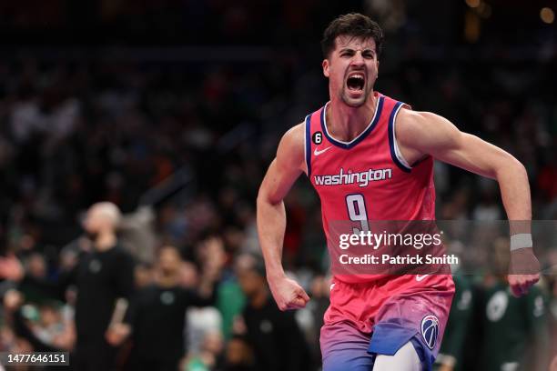 Deni Avdija of the Washington Wizards celebrates after dunking against the Boston Celtics during the second half at Capital One Arena on March 28,...