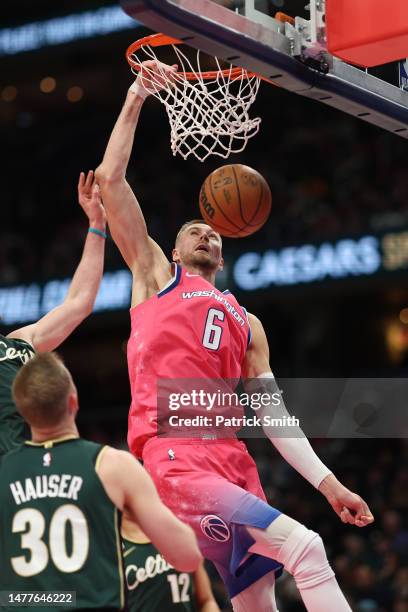 Kristaps Porzingis of the Washington Wizards dunks against the Boston Celtics during the second half at Capital One Arena on March 28, 2023 in...