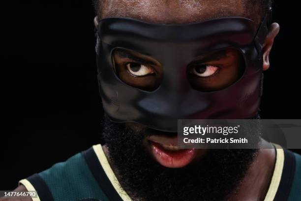 Jaylen Brown of the Boston Celtics looks on as he wears his protective face-mask against the Washington Wizards during the first half at Capital One...