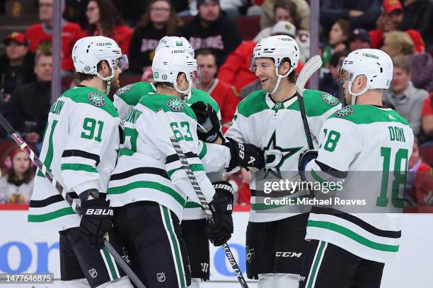 Colin Miller of the Dallas Stars celebrates with teammates after scoring a goal against the Chicago Blackhawks during the first period at United...