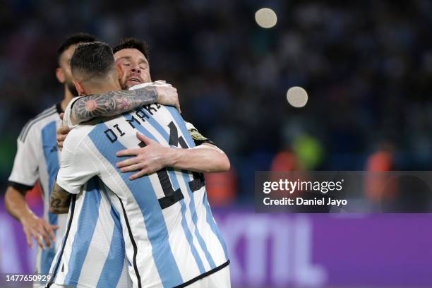 Angel Di Maria of Argentina celebrates with teammate Lionel Messi after scoring the team's sixth goal during an international friendly match between...