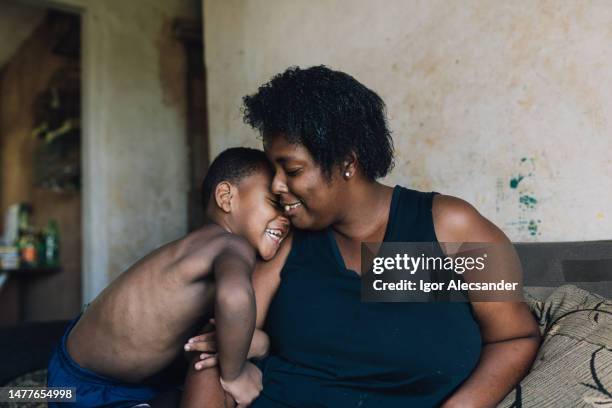 mother and son having fun at home - favela stock pictures, royalty-free photos & images