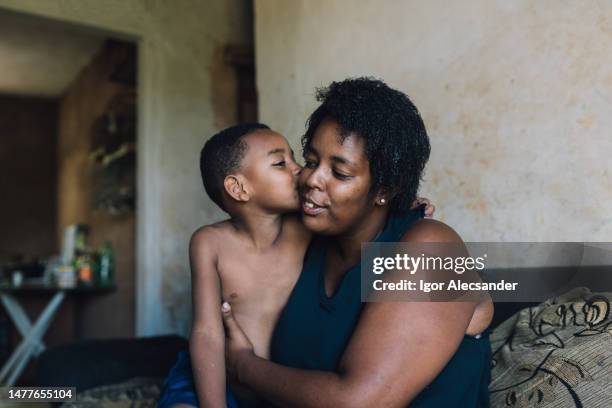 mother and son hugging at home - single mother poor stock pictures, royalty-free photos & images