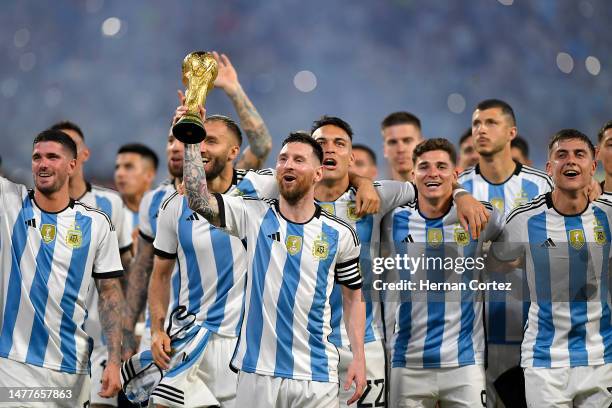 Lionel Messi of Argentina and teammates celebrate with the FIFA World Cup trophy during the World Champions' celebrations after an international...