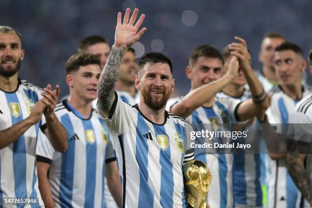 Lionel Messi of Argentina and teammates celebrate with the FIFA World Cup trophy during the World Champions' celebrations after an international...