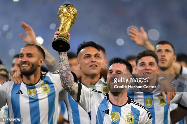 Lionel Messi of Argentina and teammates celebrate with the FIFA World Cup trophy during the World Champions' celebrations after an international...