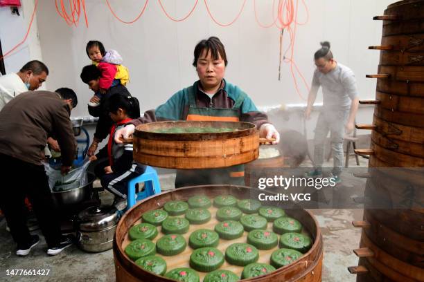 Villagers make Qingming rice cakes ahead of the Qingming Festival, or Tomb-Sweeping Day on March 28, 2023 in Jinhua, Zhejiang Province of China.