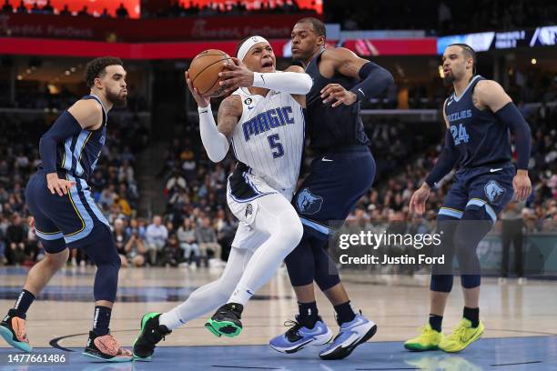 Paolo Banchero of the Orlando Magic goes to the basket against Xavier Tillman of the Memphis Grizzlies during the second half at FedExForum on March...