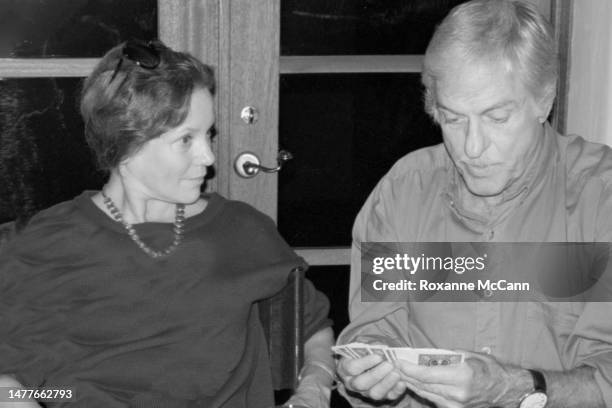 Actress Trish Van Devere and award-winning actor, comedian, singer, dancer and writer Dick Van Dyke try a card trick at a birthday party in October...