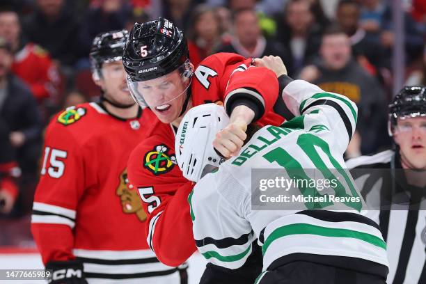 Connor Murphy of the Chicago Blackhawks fights with Ty Dellandrea of the Dallas Stars during the third period at United Center on March 28, 2023 in...